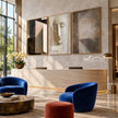 Abstract Face and Grid Triptych Painting shown in a seating area.