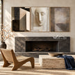 Abstract Face and Grid Triptych Painting shown near a fireplace.