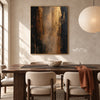 Black and Bronze Vertical Abstract Wall Art shown behind a dining table.