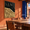 Black and Gold Faultline Painting shown in a dining area.