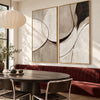 Black Arc and Gray Shape Diptych Wall Art shown behind a dining table and red bench.