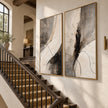 Black Brushwork and Ivory Sweep Diptych Wall Art shown beside a staircase.