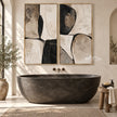 Black Curved Shapes on Cream Diptych Wall Art shown above a dark freestanding bathtub.