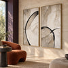 Black Loop and Fine Arc Diptych Wall Art shown beside a rust-colored chair.