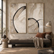 Black Loop and Fine Arc Diptych Wall Art shown above a low sofa.