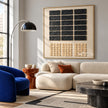 Black Rectangle Grid and Sand Squares Wall Art shown above a cream sofa beside a blue chair.