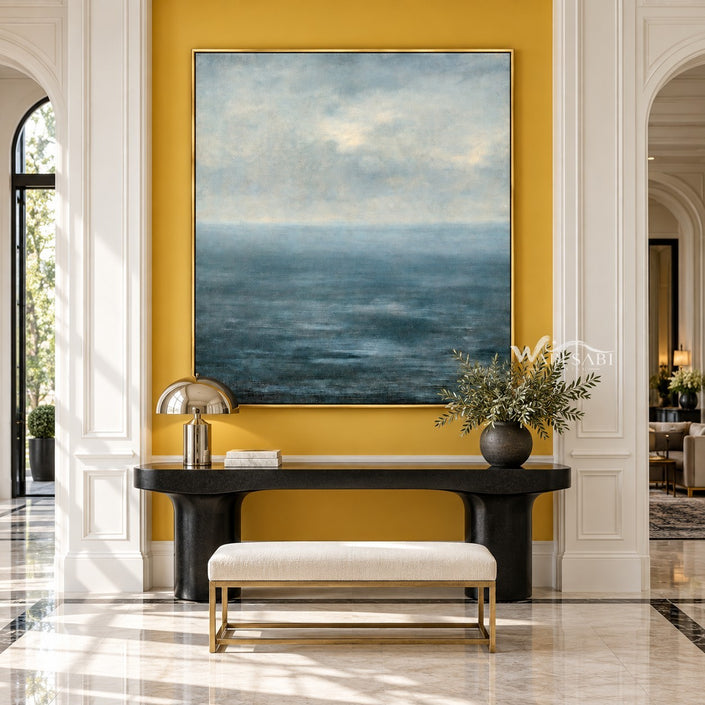 Blue Sea and Soft Cloud Horizon Wall Art shown above a console and pale bench.