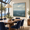 Blue Sea and Soft Cloud Horizon Wall Art shown behind a dining table.