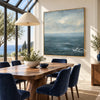Blue Sea and Soft Cloud Horizon Wall Art shown behind a dining table.