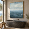 Blue Sea and Soft Cloud Horizon Wall Art shown above a freestanding bathtub.