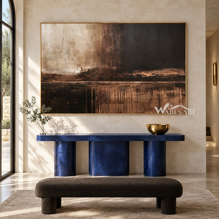 Brown Horizon Painting with Copper Reflections shown above a console.