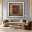 Brown Stacked Ridges on Taupe Wall Art shown above a curved pale sofa.