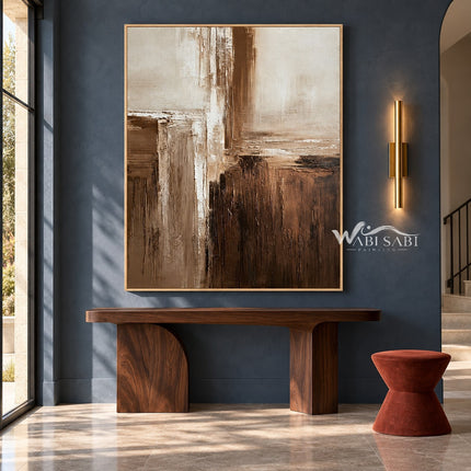 Cream and Brown Intersecting Blocks Wall Art shown above a wood console on a blue wall.