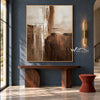 Cream and Brown Intersecting Blocks Wall Art shown above a wood console on a blue wall.