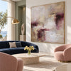 Cream and Plum Weathered Abstract Painting shown in a living room with a sofa.