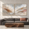 Cream and Rust Mountain Ridge Diptych shown in a living room with a sofa.