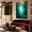 Emerald Abstract Wall Art with a Pale Center shown above a burgundy sofa.