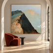 Figure above a Steep Dark Mountain Face shown beside an orange chair in an arched alcove.