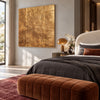 Gold Tone Creased Surface Abstract Painting shown in a bedroom.
