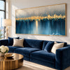 Golden Skyline over Blue Water shown above a sofa.