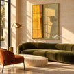 Golden Window Light and Bowed Figure Wall Art shown above a green sofa.