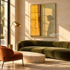 Golden Window Light and Bowed Figure Wall Art shown above a green sofa.