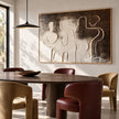 Interlocking Black and White Figures Painting shown in a dining area.