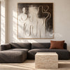 Interlocking Black and White Figures Painting shown in a living room with a sofa.