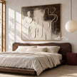 Interlocking Black and White Figures Painting shown in a bedroom.
