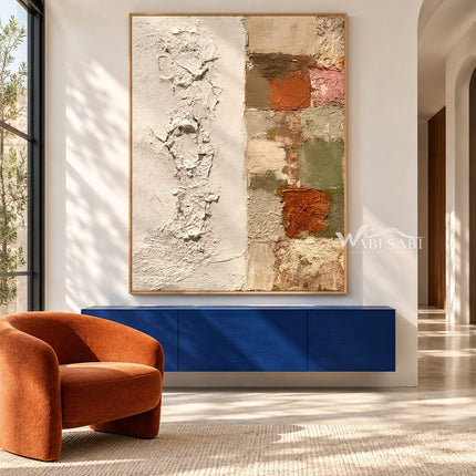 Ivory Texture and Earth Tone Blocks Wall Art shown above a blue console beside an orange chair.