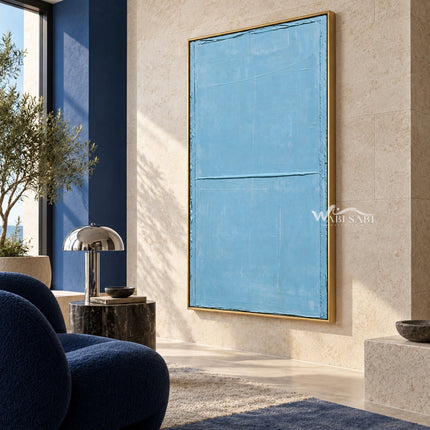 Light Blue Field with a Horizontal Line Wall Art shown beside blue lounge seating.