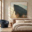 Lone Figure on a Broad Mountain Ridge Wall Art shown above a bed with neutral bedding.