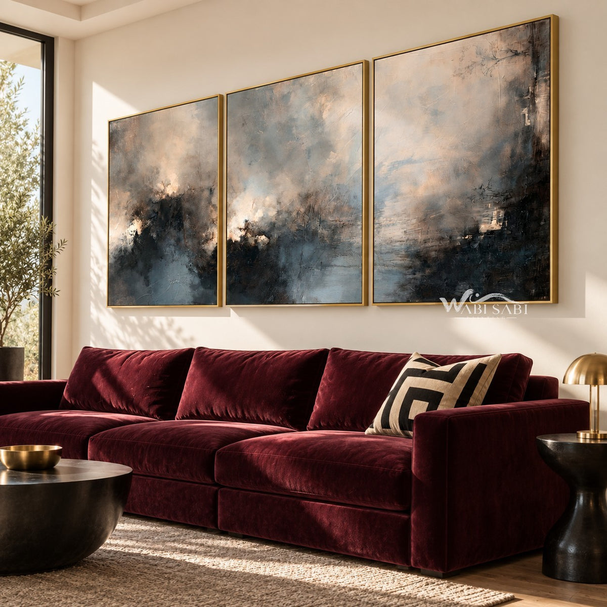 Misty Blue and Charcoal Landscape Triptych shown above a burgundy sofa.