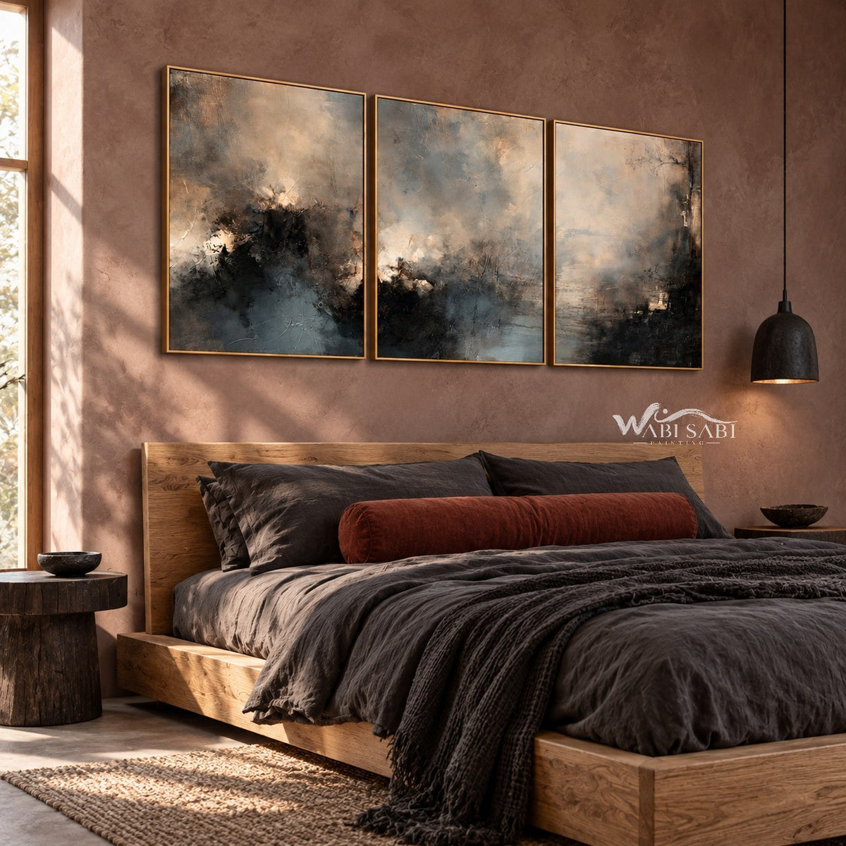 Misty Blue and Charcoal Landscape Triptych shown above a bed with dark bedding.