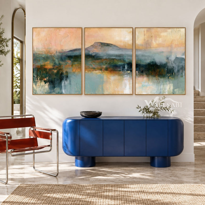 Misty Mountain Lake Painting in Three Panels shown above a console.