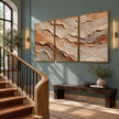 Ochre and Ivory Strata Triptych Wall Art shown beside a staircase.