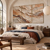 Ochre and Ivory Strata Triptych Wall Art shown above a bed with a rust-colored throw.