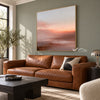 Peach Sunset over Quiet Water Wall Art shown above a brown leather sofa.