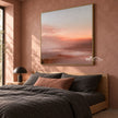 Peach Sunset over Quiet Water Wall Art shown above a bed with dark bedding.