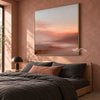 Peach Sunset over Quiet Water Wall Art shown above a bed with dark bedding.