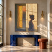 Quiet Figure beside an Amber Window Wall Art shown above a blue console.