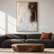 Raised Line Seated Figure Abstract Painting shown in a living room with a sofa.