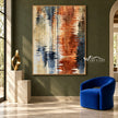 Rust and Navy Water Reflection Abstract Wall Art shown beside a blue chair on a green wall.