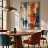 Rust and Navy Water Reflection Abstract Wall Art shown above a dining table.