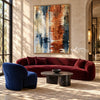 Rust and Navy Water Reflection Abstract Wall Art shown above a burgundy sofa.
