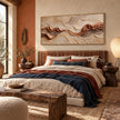 Rust Seam and Cream Contour Wall Art shown above a bed with blue bedding.