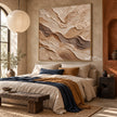 Sand and Brown Swirled Strata Wall Art shown above a bed with a blue throw.