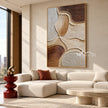 Sandstone Curves Abstract Canvas shown above a sofa.