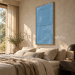 Slate Blue Minimal Line Wall Art shown above a bed with pale bedding.