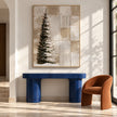 Snowy Evergreen and Neutral Grid Painting shown above a console.
